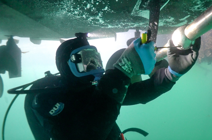 hull cleaning. diver replacing anodes