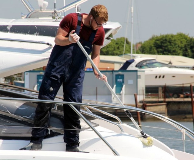 man scrubbing a boat